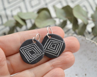 Round black dangle earrings with white geometric pattern, handmade ceramic jewelry