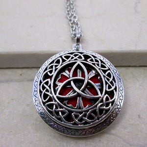 Celtic trinity knot locket necklace, with interchangeable color pads for essential oil. antique silver color,