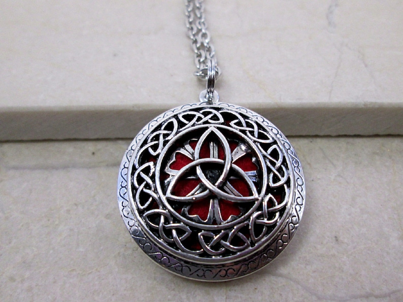 Celtic trinity knot locket necklace, with interchangeable color pads for essential oil. antique silver color,