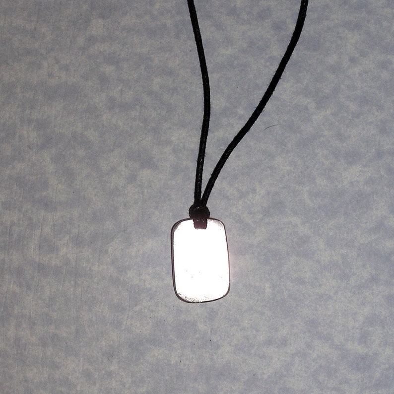 Back view of pendant, showing pendant polished with mirror finish.