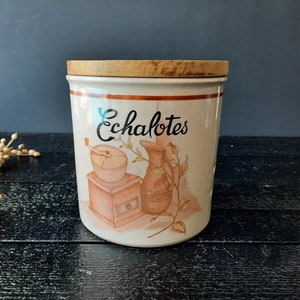 May include: A white ceramic jar with a wooden lid, featuring a hand-painted design of a coffee grinder, a jug, and the word "Echalotes".