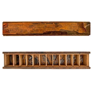 May include: A vintage wooden storage box with twelve compartments containing metal spring bars. The lid features a weathered orange label with the text "DEBBIE" DOUBLE FLANGE SPRING BARS, listing technical specifications and product details.