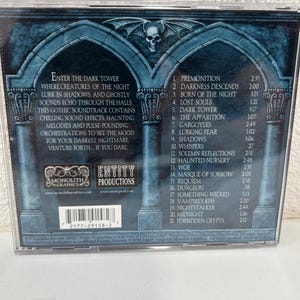 May include: A gothic soundtrack CD case with a dark blue and gray design. The cover features a skull and architectural elements. Text includes "Enter the Dark Tower" and a tracklist. The CD case is in a clear plastic jewel case.
