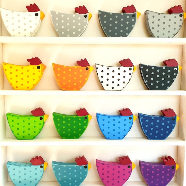 colorful good mood chickens made of wood in different colors table decoration Easter egg points