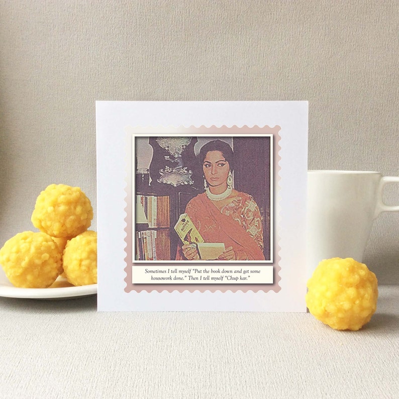 May include: A white card with a pink border and a photo of a woman holding a book. The text on the card reads "Sometimes I tell myself "Put the book down and get some housework done." Then I tell myself "Chap kan""