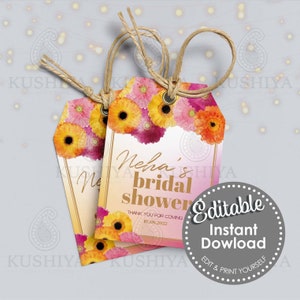 Könnte beinhalten: Zwei Geschenkanhänger mit floralen Designs und dem Text "Neha's bridal shower". Die Anhänger haben einen Farbverlauf im Hintergrund und sind mit gelben, rosa und orangefarbenen Blumen verziert. Jeder Anhänger hat eine Schnurschlaufe.