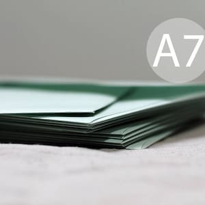 May include: A stack of A7 size paper in a light green color. The paper is folded in half and the edges are visible.