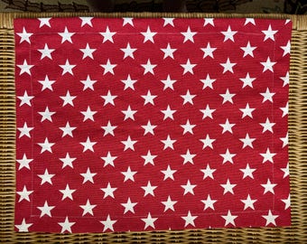 Set of 6 cotton canvas placemats in lipstick red with white stars, unlined, 13 1/2 x 17 1/2 inches.