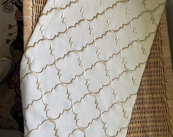 Small table runner in a gold "ogee" pattern on a golden tan cotton/poly blended fabric.