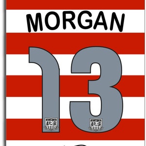 May include: Red and white striped name tag with the name "MORGAN" and the number "13" in gray. The tag also has a small logo with the text "SWAG A TAG" and the phrase "Get your SWAG on!"