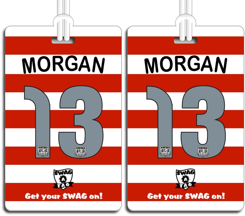 May include: Two red and white striped luggage tags with the name "MORGAN" and the number "13" printed on them. The tags have a black and white logo with the text "SWAG TAG" and the text "Get your SWAG on!" printed on them.