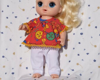 Cute red dress in a buttons and bow print trimmed in yellow lace with white leggings, fits 13 inch baby dolls