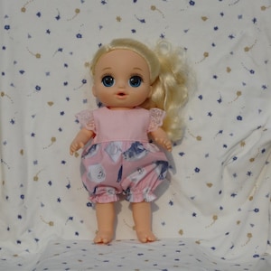 Cute pink one-piece shorts outfit in a gray and white kitty print pink lace sleeves, fits 13-inch baby dolls