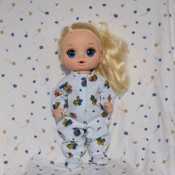 Cute light blue flannel sleeper in baby toy print fits 13-inch baby dolls