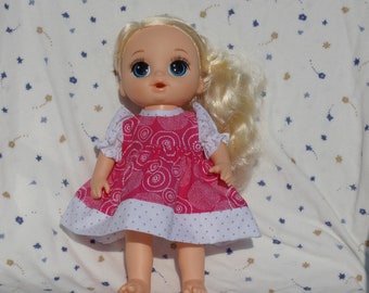 Pretty pink dress in a swirl white print trimmed in white and gray polka dot print fits 13 inch baby dolls