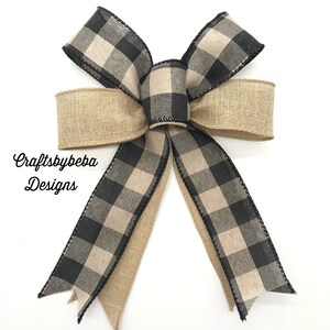 May include: A black and white buffalo check ribbon bow with a burlap ribbon accent. Craftsbybeba Designs is printed on the burlap ribbon.