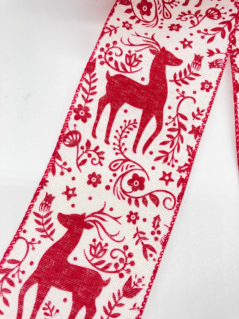 May include: Red and white ribbon with a repeating pattern of reindeer and floral designs. The ribbon has a white background with red reindeer and floral designs.