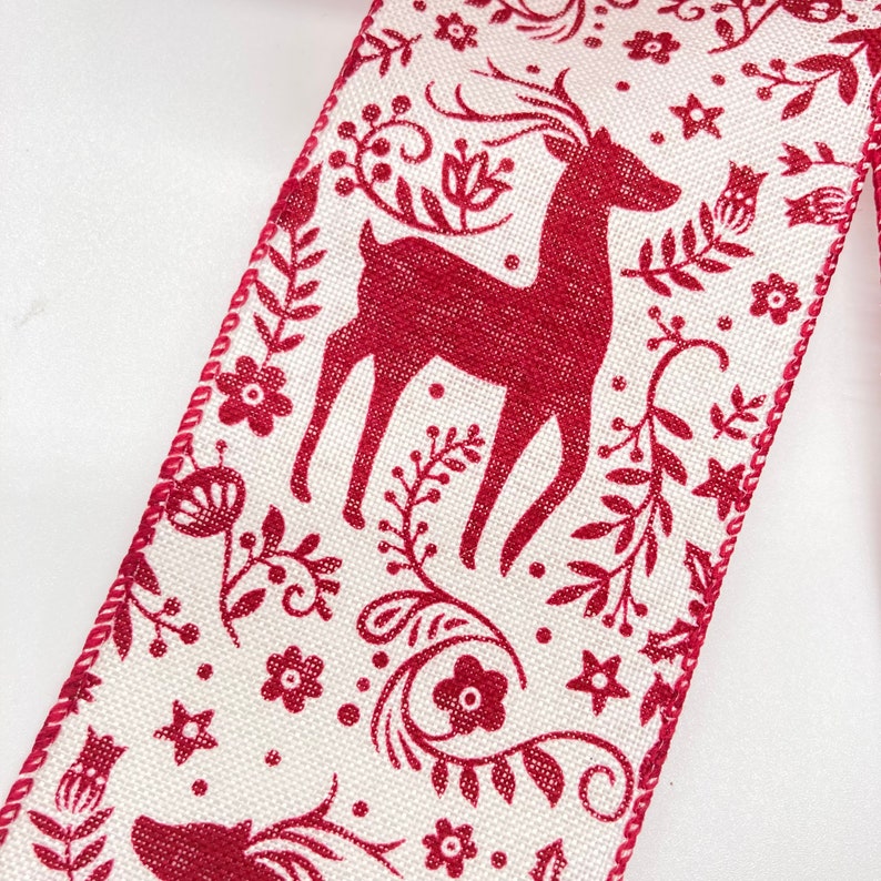 May include: Red and white ribbon with a repeating pattern of a stylized reindeer and floral designs.