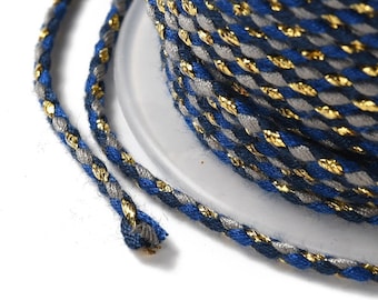 May include: A spool of blue, grey, and gold braided cord. The cord is twisted and has a metallic sheen.
