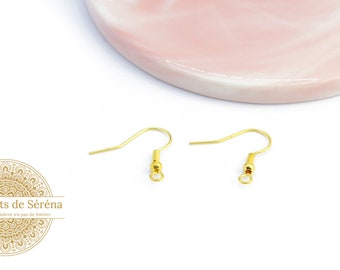 May include: Two gold-toned earring hooks with a small round ball at the top of each hook.