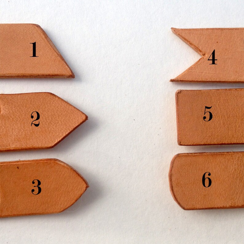 May include: Six different leather pieces with numbers 1 through 6 printed on them. The pieces are all different shapes and sizes.