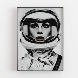 May include: Black and white illustration of a person wearing an astronaut helmet. The person's face is visible through the helmet's visor. The helmet has a white background with black dots.