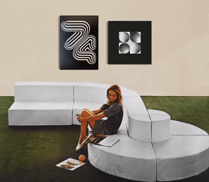 May include: A white modular sofa with a curved design, featuring a woman sitting on the sofa wearing a black and white polka dot dress. Two black framed prints hang on the wall behind the sofa. One print features a black and white geometric design, and the other print features a black and white design of overlapping circles.