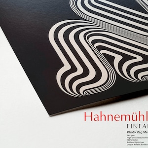 May include: Black and white abstract art print on a textured metallic paper. The print features a series of curved lines that create a sense of movement and depth. The paper is 340 gsm, high gloss, textured, acid and lignin-free, and has a unique metallic surface. Hahnem&uuml;hle FineArt Photo Rag Metallic.