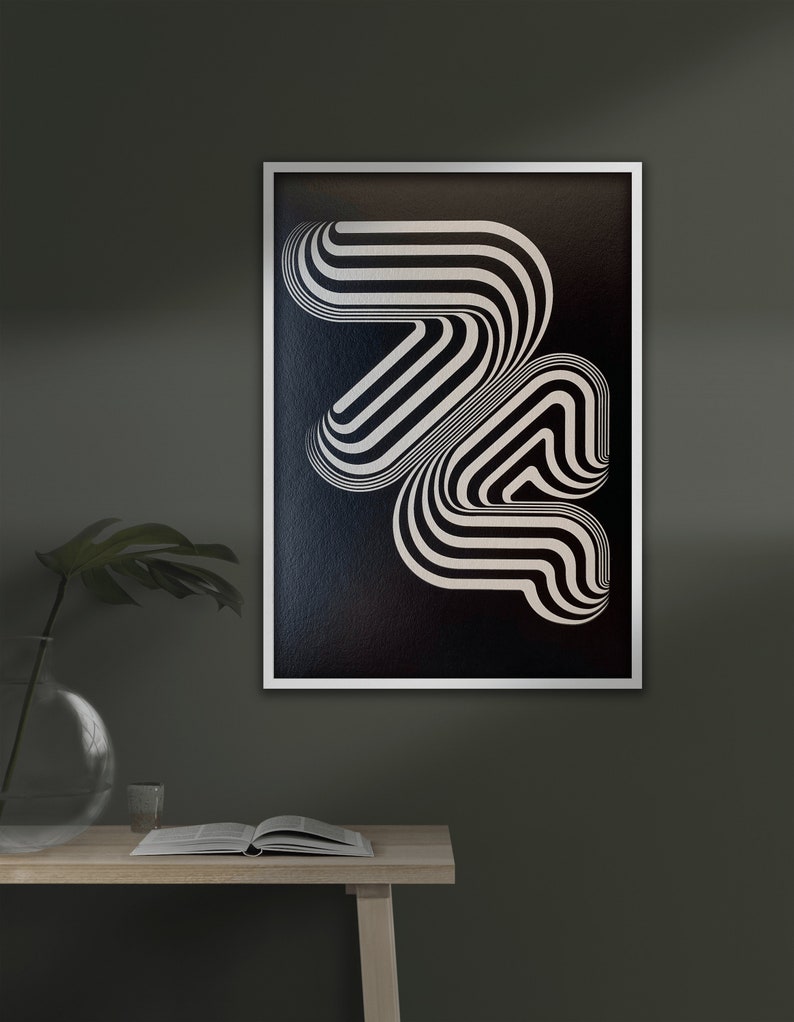 May include: A black and white abstract geometric print in a white frame. The print features a series of curved lines that create a sense of movement and depth.