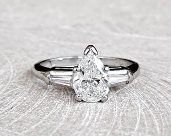 Anillo de compromiso de platino con diamantes en forma de pera: 1,03 quilates SI1/H, detalles en talla baguette, tasación GIA G.G.