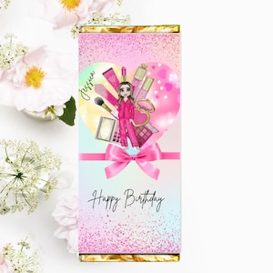May include: Pink and white chocolate bar wrapper with a heart-shaped design featuring a cartoon girl and makeup items. The text "Happy Birthday" is printed below the heart. The girl's name "Jessica" is written on the left side of the heart.