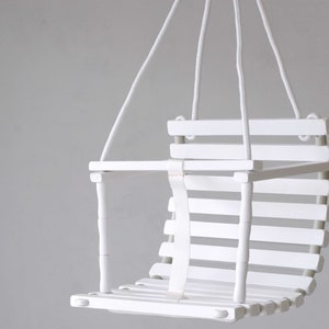 Wooden baby swing with engraved message option on the back of the swing in white color made of birch wood.