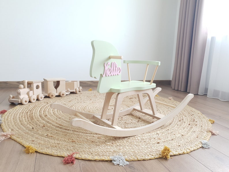 Customizable wooden rocking horse with personalized name on horse head, available in a range of vibrant and pastel colors.