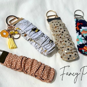 May include: A set of three ceramic mugs with a speckled, matte finish. The mugs are in shades of cream, light gray, and dark gray. Each mug has a simple, minimalist design, perfect for coffee or tea.