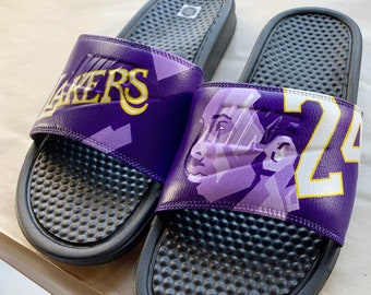 purple and gold nike slides