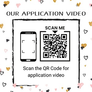 May include: A white background with a black and white QR code and the text "SCAN ME" above it. Below the QR code is a black and white image of a smartphone with a camera icon. The text "Scan the QR Code for application video" is below the image. The background is decorated with pink and gold hearts.