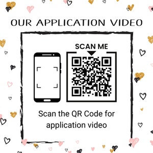 May include: A white background with a black and white QR code and the text "SCAN ME" above it. Below the QR code is a black and white image of a smartphone with a camera icon. The text "Scan the QR Code for application video" is below the image. The background is decorated with pink and gold hearts.