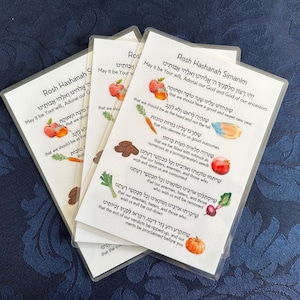 May include: Four cards with Hebrew text and illustrations of fruits and vegetables. The cards are for Rosh Hashanah, the Jewish New Year. The text on the cards includes the phrase "May it be Your will, Adonal our God and God of our ancestors that we should have a good and sweet new year."