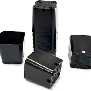 May include: A set of four black plastic square plant pots. The pots are 4 inch square and are stacked on top of each other.