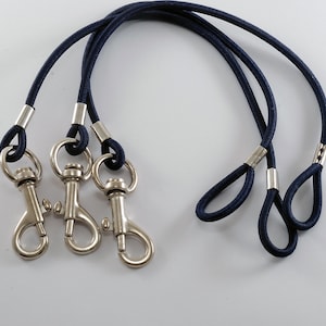 May include: Three navy blue lanyards with silver swivel clips.