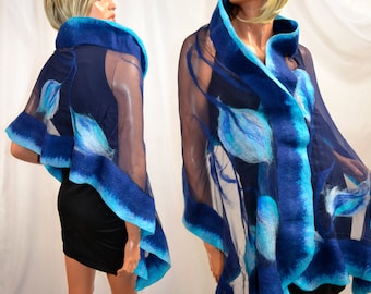 May include: A blue and turquoise sheer shawl with a floral design. The shawl is made of wool and silk and has a soft, drapey feel.