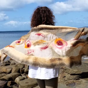 Back view of the khaki and beige felted shawl with artistic flower motifs, wearable art style.