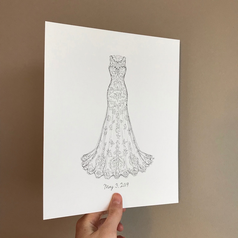 May include: A black and white line drawing of a wedding dress with a lace design. The drawing is on a white background and includes the date "May 3, 2019".