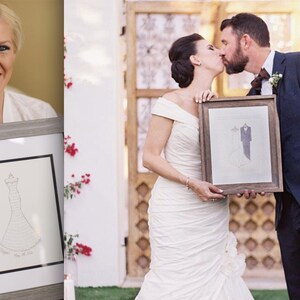 May include: A framed drawing of a wedding dress and a suit, with the bride and groom kissing in the background.