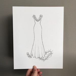 May include: A line drawing of a wedding dress with a floral neckline and a flowing skirt. The dress is surrounded by floral embellishments.
