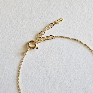 May include: Gold chain bracelet with a lobster clasp and a small tag that says "S925".