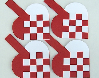 May include: Four red and white woven heart-shaped paper crafts. Each heart has a white center and red woven edges.
