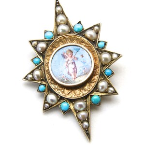 May include: A gold-toned starburst brooch featuring a central oval with a painted cherub scene. The brooch is adorned with pearls and turquoise stones. The design is intricate and detailed, with a vintage aesthetic.