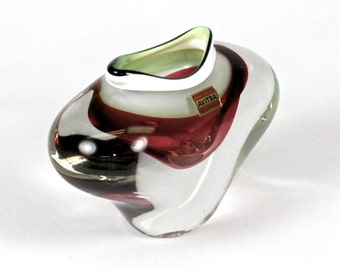 May include: A clear glass vase with red, white and green stripes. The vase has a unique, organic shape and is made by Avitra.