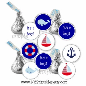 May include: Set of 12 printable round stickers for favors. The stickers feature a nautical theme with a whale, sailboat, anchor, and life preserver. The stickers are blue, red, and white and say "It's a boy!"